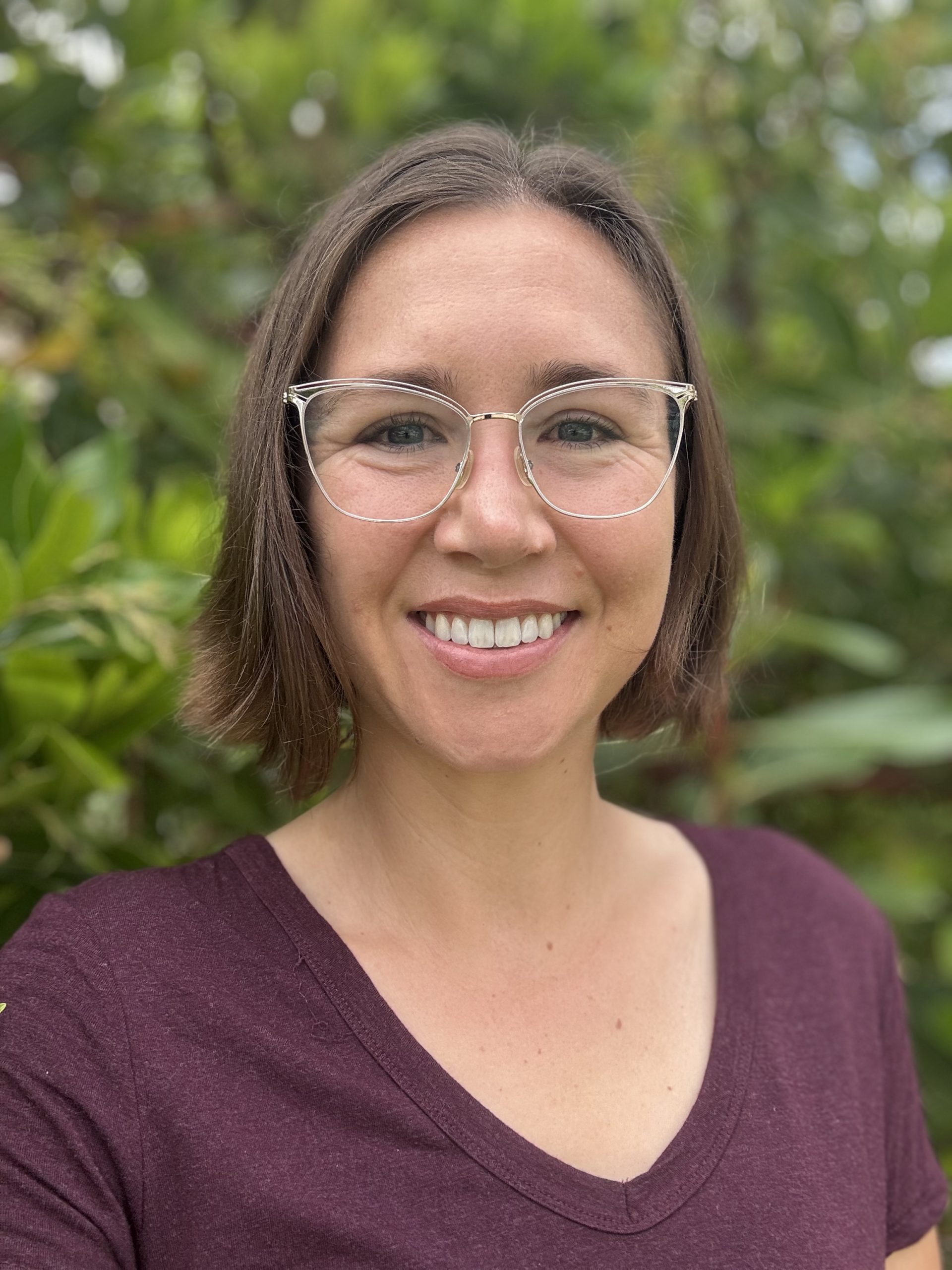 Picture of author Kristen Hornung, a woman with brown hair wearing glasses